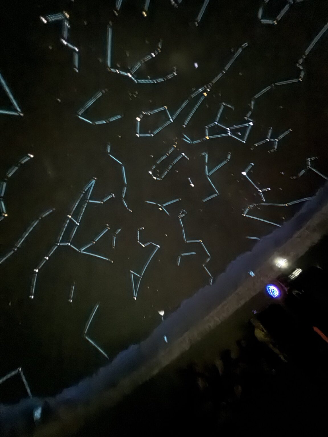 Constellation figures illustrated over the night sky inside the planetarium dome.