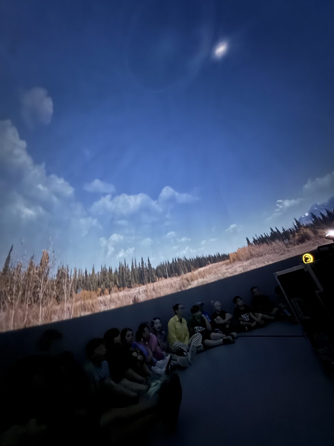 A landscape horizon projected across the inside of a modern digital planetarium dome.