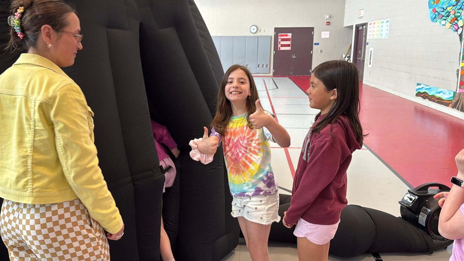 Students lining up to enter a walk-in mobile planetarium at their school.